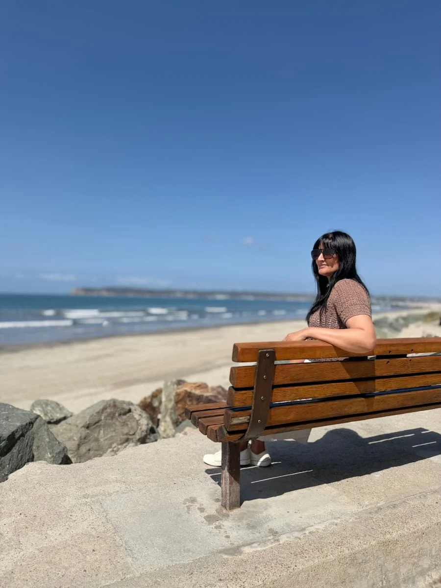 Bejal on a bench overlooking the Pacific coast at Coronado